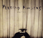 Feeding Fingersin albumin "Baby Teeth" etukannessa valokuva lautaseinästä, joka on vaalea, ja jonka alaosassa näkyy jonkinlainen ihmisen hiustupsu tai hiustöyhtö. Kuvan yläosassa mustalla värillä ja käsin rustattuna yhtyeen nimi, jonka alla piene