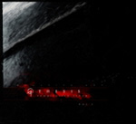 "Thesis Volume 1" -kokoelman etukannessa näkyy musta pohjaväri ja sen vasemmassa alakulmassa näkyy punaisena hohtavaa ainetta, jonka sisällä lukee jotakin lukukelvotonta tekstiä.