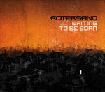 Rotersandin nimi mustalla kuvan oikeassa laidassa. Sen alapuolella valkoisella värillä "Waiting To Be Born". Kuvan taustalla oranssi taivas ja sen alla musta suurkaupunki.