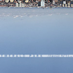 Valokuva sinisestä vedestä ja sen yläosassa näkyvästä rantapenkereestä. Kuvan alaosassa lukee vaaleaa taustaa vasten yhtyeen nimi ja oikealla pienellä präntillä "Reality Bites / Someone to Love".