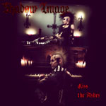 "Kiss The Ashes" -albumin etukannessa kaksi goottia. Yllä on nainen, alla mies. Molemmilla puolikalju ja naisella myös irokeesi. Kuvan yläosassa Shadow Image -goottibändin logo.