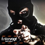 Kommandopipoa kasvoillaan pitävä henkilö osoittaa sormellaan eteenpäin.