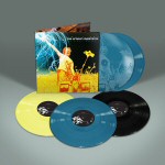 Harmaata taustaa vasten eri värisiä vinyylilevyjä.