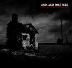 Mustavalkoinen ja aavemainen valokuva rakennuksesta, joka seisoo yksin tumman ja uhkaavan taivaan alla. Kuvan oikeassa yläkulmassa lukee And Also The Trees valkoisella värillä.