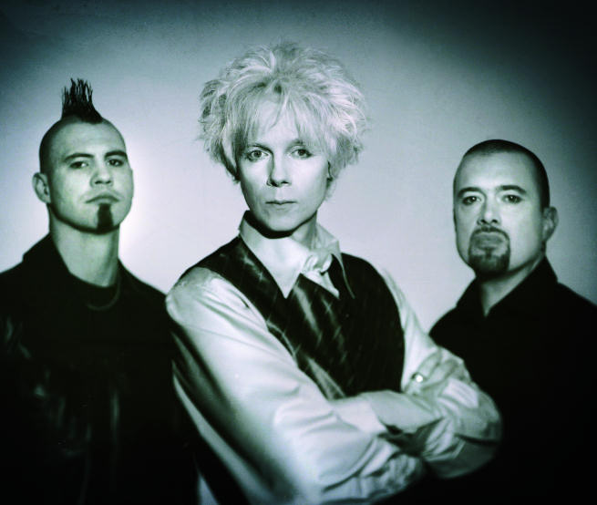 Vihertäväsävyinen ja hämyisä pressipotretti The Beauty of Gemina -nimisestä goottibändistä, johon kuuluu kolme tummiin pukeutunutta mieshenkilöä. Keskimmäisellä valkoinen tukka, vasemman laidan miehellä musta irokeesi.