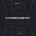 Kuvassa näkyy "Love It or Leave It" -kiekon kansitaide, joka on tummanharmaalle pohjavärille sullottu metallikehikko, joka erottuu hyvin hämärästi taustastaan. Kuvan ylä- ja alaosassa pientä pränttiä valkoisella värillä. Keskellä kuvaa Rise an
